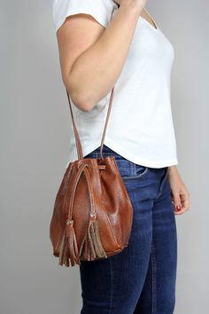 Mini Leather Bucket bag - caramel brown drawstring bag. Unlined The 35.5 inch (90 cm) strap has no adjustment. Brown Bucket Shoulder Bag With Dust Bag, Brown Bucket Bag For Everyday Use, Casual Brown Hobo Bucket Bag, Brown Bucket Bag For Daily Use With Phone Pocket, Brown Hobo Bag With Adjustable Strap As Gift, Brown Pouch Bucket Bag For Gift, Brown Bucket Pouch For Everyday Use, Casual Brown Pouch For Everyday Use, Casual Brown Pouch For Everyday