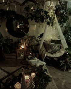 a living room filled with lots of furniture and christmas decorations on the wall next to candles