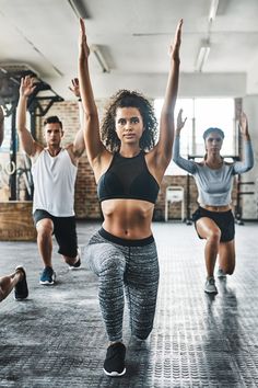 a group of people doing exercises in a gym