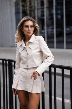 Colors: Ivory, Warm Gray, Mocha Sizes: XS (2 US), S (4 US), M (6 US), L (8 US), XL (10 US), 2XL (12 US), 3XL (14 US)  Model description: Skirt with shorts underneath, buttoned jacket with pockets Material: Suit cotton, viscose shorts, jacket with viscose lining Elevate your style with this Women's Cotton Skirt Suit 2 Piece Set, featuring a chic crop blazer with pockets and a flattering pleated mini skirt. This versatile outfit is designed for both style and comfort, making it an ideal choice for Suit Dress Women, Blazer With Skirt, Petite Suits, Blazer And Skirt Set, Crop Blazer, Stylish Skirts, Versatile Outfits, Cotton Skirt, Pleated Mini Skirt