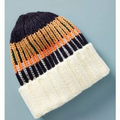 a multicolored knitted beanie on a blue background