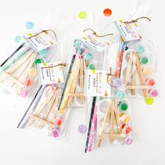 several wooden sticks with different colored dots on them and tags attached to the top one