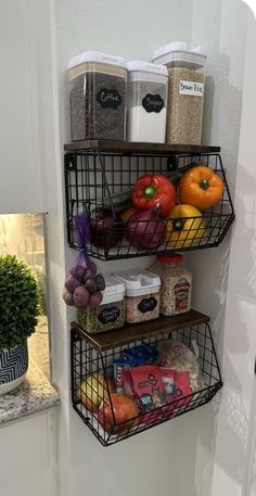 two metal baskets filled with food on top of a refrigerator