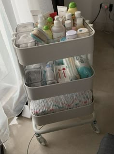 a cart filled with lots of different types of personal care products on top of a floor