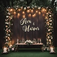 an outdoor ceremony with candles and flowers on the table, surrounded by greenery that reads ava & harper