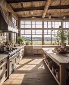 a large kitchen with lots of windows and wooden flooring