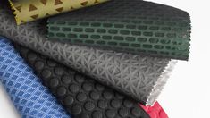 several different types of fabrics stacked on top of each other, all in different colors