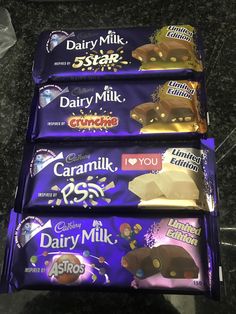 three bars of dairy milk chocolate sitting next to each other on top of a counter