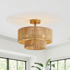 a living room with a couch, coffee table and chandelier hanging from the ceiling