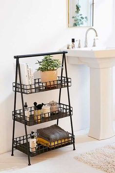 a bathroom with a sink, mirror and shelving unit on the floor in front of it