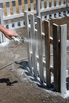 a man is spraying concrete with a hose