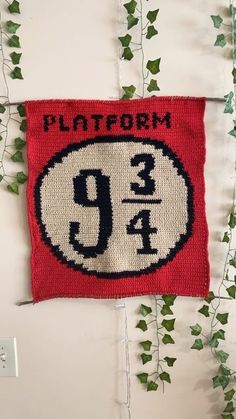 a knitted patch with the number 94 on it and ivy growing up behind it