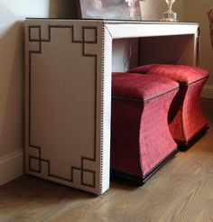 a small white table with a red blanket on it