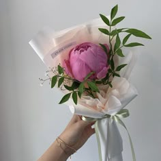 a person holding a bouquet of flowers in their hand