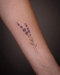 small lavender flower tattoo on the arm