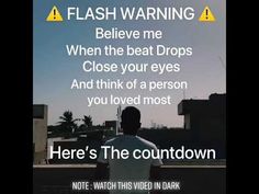 a man standing on top of a roof next to a sign that reads, flash warning believe me when the beat drops close your eyes and think of a person you loved most