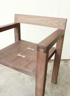 a wooden chair sitting on top of a cement floor