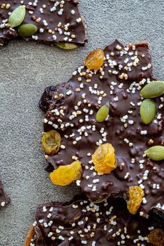 an image of chocolate bark with nuts and sprinkles on the top in front of it