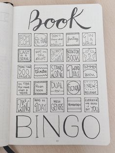 an open notebook with the words book bingo written in black ink on top of it