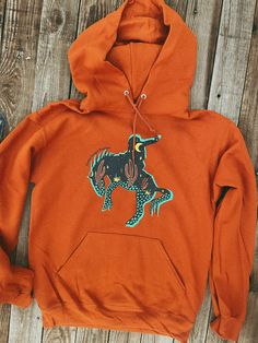 Our bestselling exclusive design on a rusty orange hoodie. Unisex fit Classic hooded sweatshirt Pictured wearing a small Western Hoodies, Cute Western Outfits