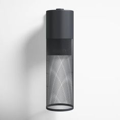 a black light hanging from the side of a white wall with a gray mesh covering