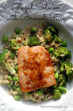 salmon with broccoli rice and peas in a white bowl on top of a table