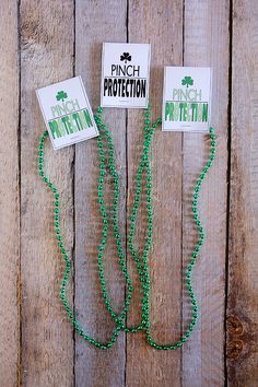 two green beads are attached to each other on a wooden surface with the words pinch protection written above them