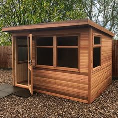 a small wooden shed sitting in the middle of a yard