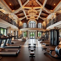 a large gym with treadmills, exercise bikes and other equipment in the room