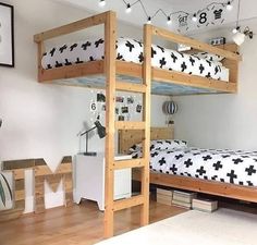 a bedroom with bunk beds and pictures on the wall above it, along with other furniture