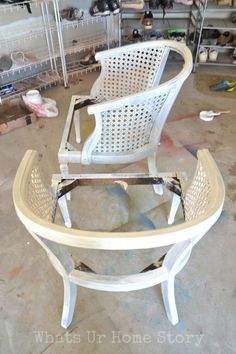 two white chairs sitting on top of a table