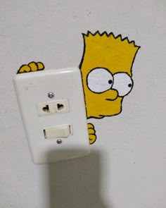 a white light switch sitting next to a cartoon character sticker on the side of a wall