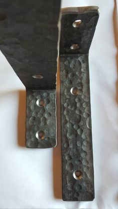 two pieces of metal with holes in them