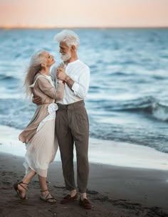 an older couple hugging on the beach with quote about love and life in front of them