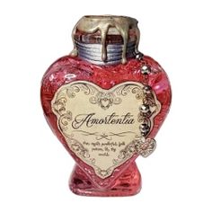 a red glass bottle with a heart on it