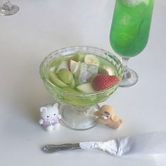 a glass bowl filled with fruit sitting on top of a table