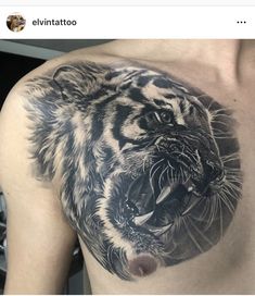 a black and white tiger tattoo on the chest