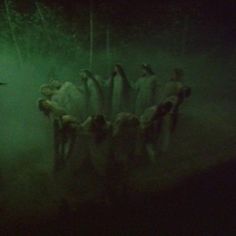 a group of people standing next to each other in the dark