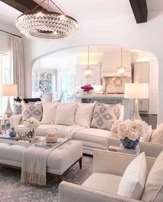 a living room filled with furniture and a chandelier