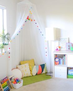 a child's room with a bed, bookshelf and toys on the floor