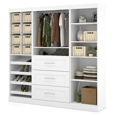 an open closet with white shelves and baskets on the bottom shelf, filled with clothes