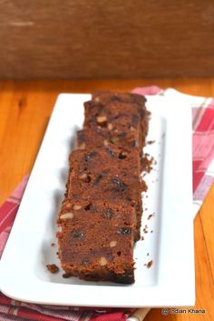 a loaf of chocolate cake on a white plate