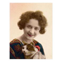 an old photo of a woman holding a cat in her arms and smiling at the camera