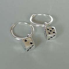 A PAIR of sterling silver hoops. Comes with a detachable dice charm. The charm is multipurpose and can be used with a neck or bracelet chain too. Dimension: Hoop- 12x1 mm Charm: 5 x8 mm Drop length- 19 mm These earrings are made of real 925 hypoallergenic sterling silver. Please let me know if you want the piece in a gift box. I can write out a message from you to the receiver if needed. Please be free to contact me at... bhavnakwintra1956@gmail.com More hoops: https://www.etsy.com/your/shops/Th Silver Sterling Silver Huggie Earrings For Gift, Silver Round Huggie Earrings Gift, Minimalist Charm Earrings For Gifts, Nickel-free Silver Dangle Huggie Earrings, Silver Nickel-free Dangle Huggie Earrings, Silver Dangle Huggie Earrings Nickel-free, Silver Huggie Earrings With Charms, Silver Charm Hoop Earrings, Nickel-free Sterling Silver Huggie Earrings As Gift