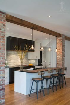 an open concept kitchen and dining area with wood flooring