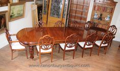 a large wooden dining table surrounded by chairs