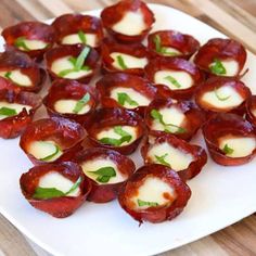 small appetizers are arranged on a white plate