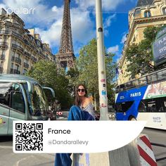 a woman is sitting on a pole in front of the eiffel tower, paris