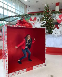 a woman in a red and white box with christmas decorations