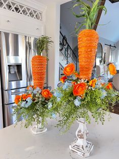 two vases filled with flowers on top of a table